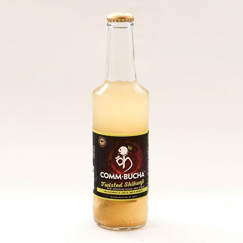 A 330ml glass bottle containing Lemon Mint kombucha sealed with a crown cap